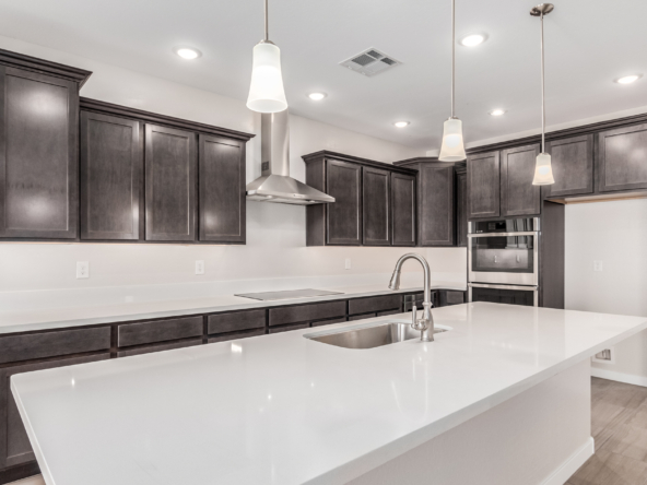 Marigold 4412 Floor Plan gourmet kitchen with dark cabinets and white quartz