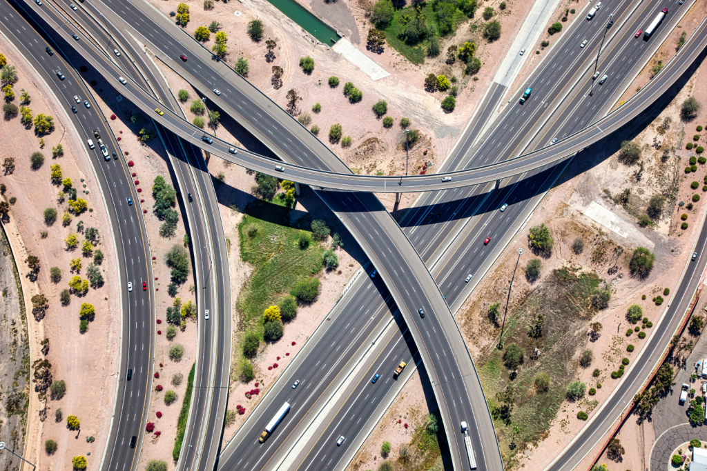 An aerial view of a busy highway interchange similar to Loop 303 and Happy Valley Rd
