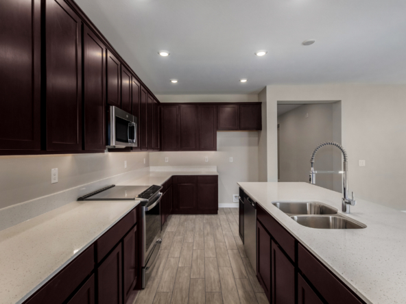 The Poppy floorplan featuring an upgraded induction range at the kitchen.