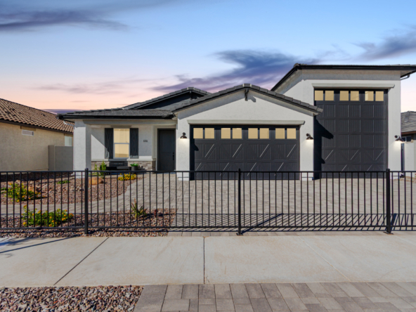 The Journey Model Home as seen from the street with a beautiful sunset behind