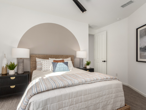 Journey model home 2nd bedroom with a large bed