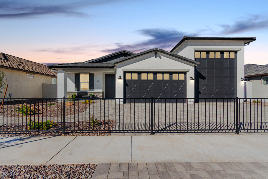 The Journey model home as seen from the street with a sunset behind