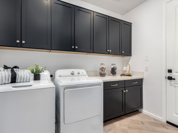 The journey model home laundry room with built-in cabinets