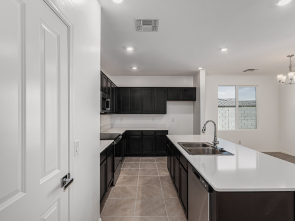 Discovery RV home's kitchen with espresso cabinets and white quartz