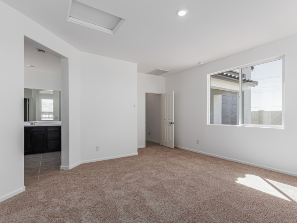 Discovery RV home master bedroom with a view into the bathroom