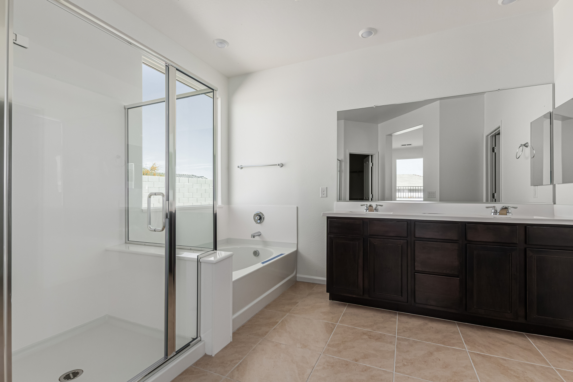 Discovery RV home master bath featuring a step in shower and seperate bathtub