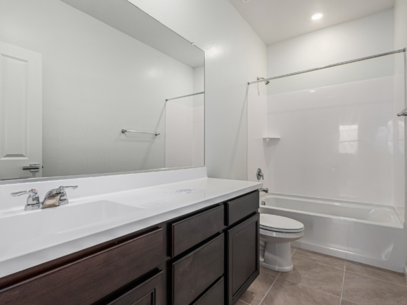 Discovery RV home secondary bath with a long vanity and bathtub