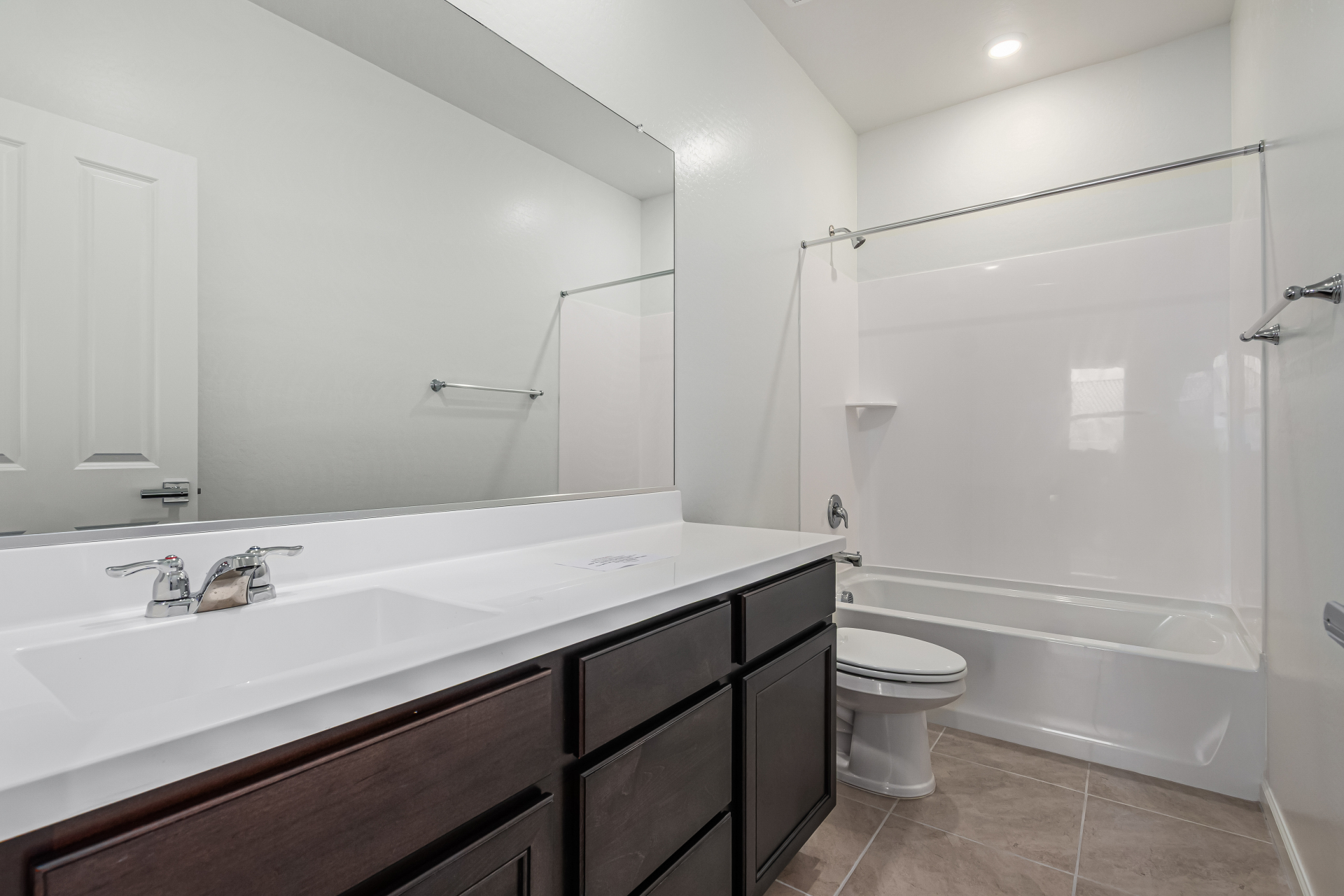 Discovery RV home secondary bath with a long vanity and bathtub