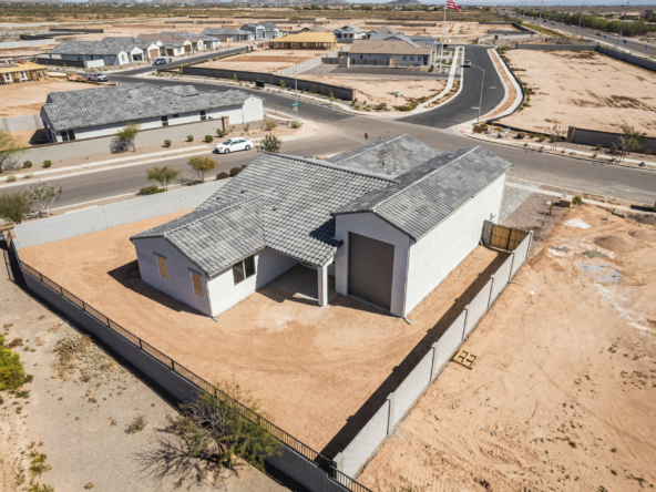 Discovery RV home's rear yard as seen from a drone showing a second garage door on the rear of the home