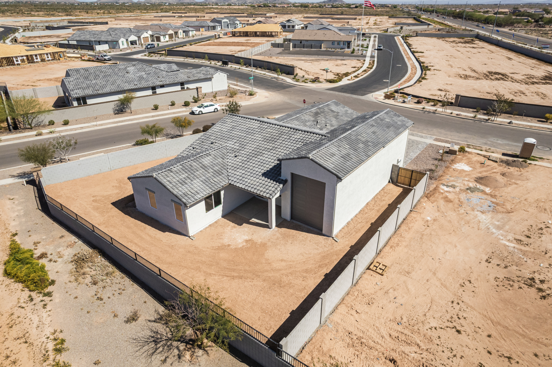Discovery RV home's rear yard as seen from a drone showing a second garage door on the rear of the home