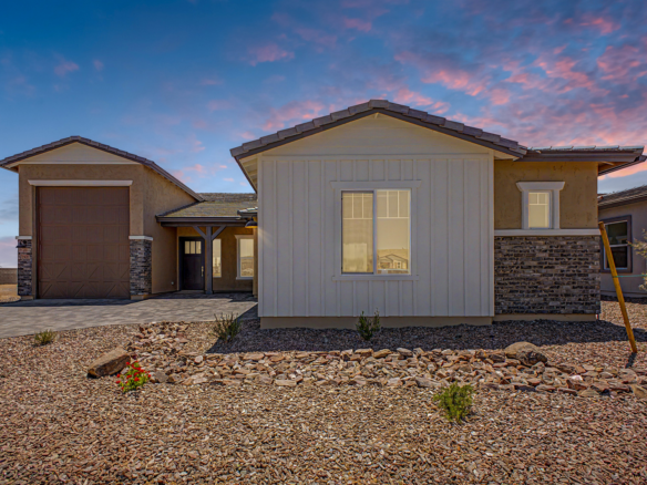 Tranquility RV floor plan as seen from the street with a twilight sunset behind it