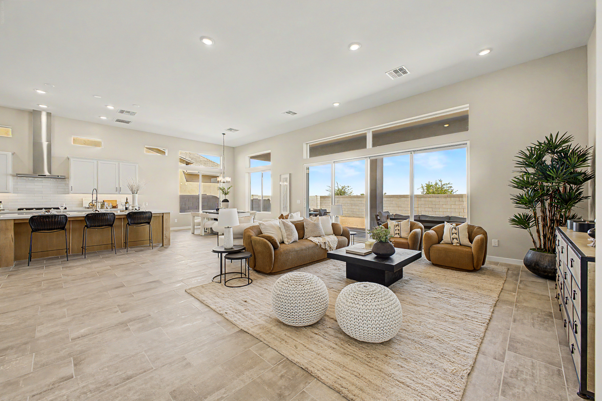 Lavish Floor Plan great room showcasing oversized glass sliding doors and windows