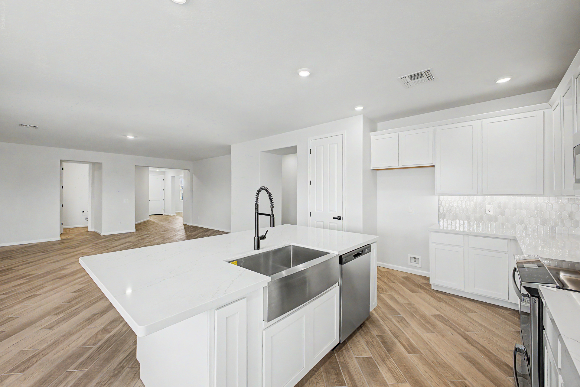 kitchen of the journey plan featuring white cabinets and a farmhouse sink