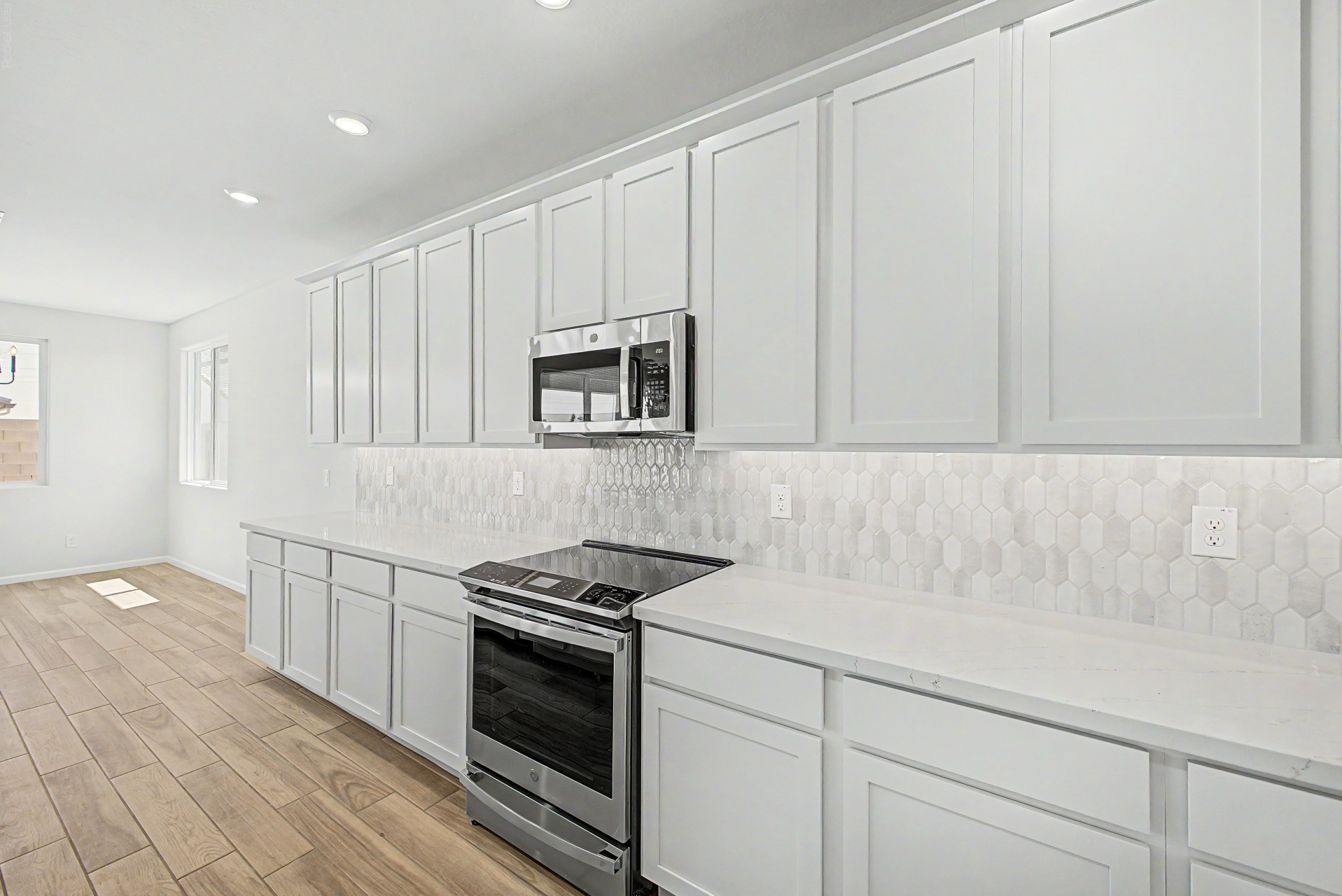 kitchen of a violet 4414 floor plan featuring upgraded appliances and a tiled backsplash