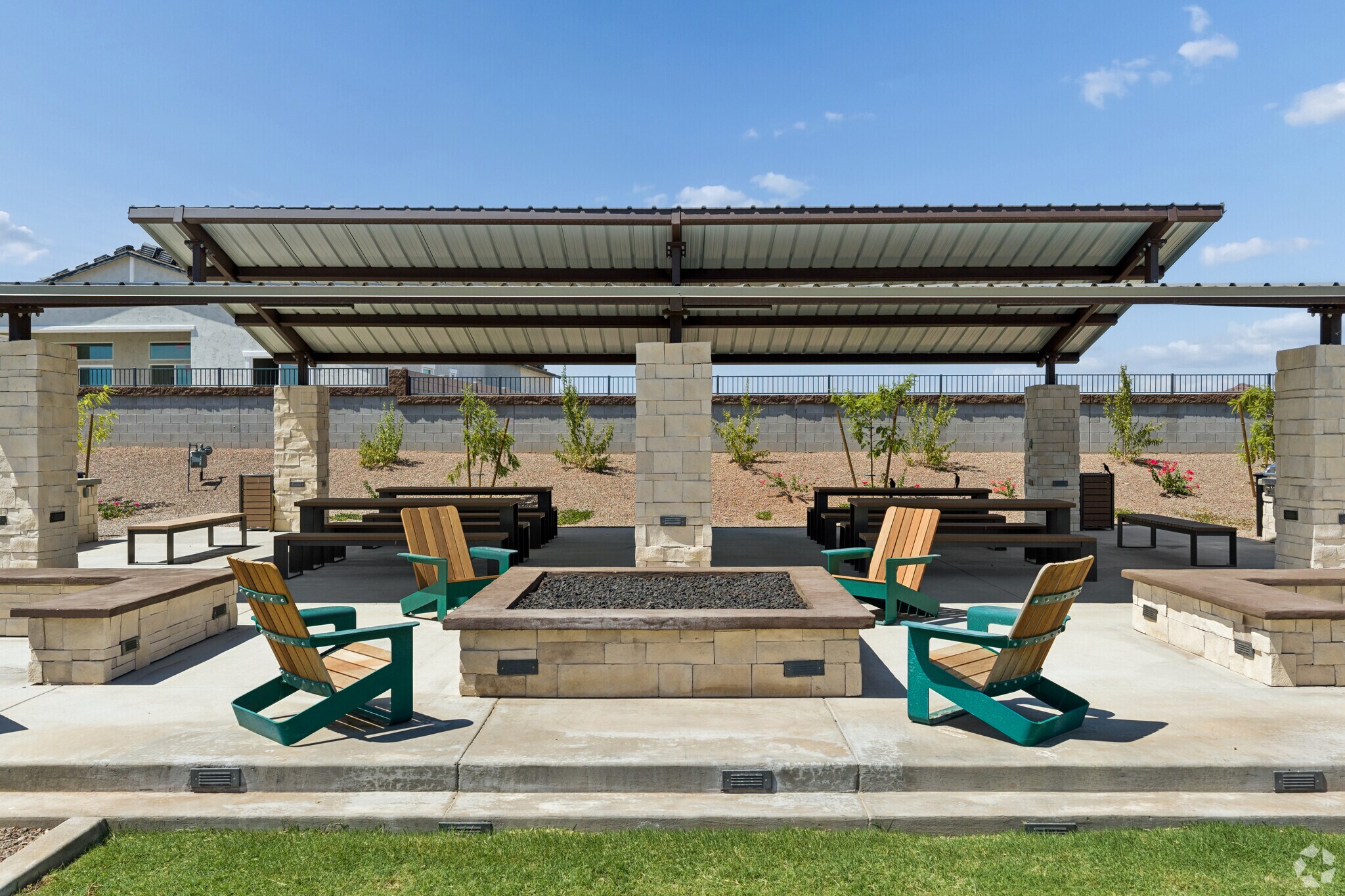 view of the community's pavilion including a fire pit with adirondack chairs